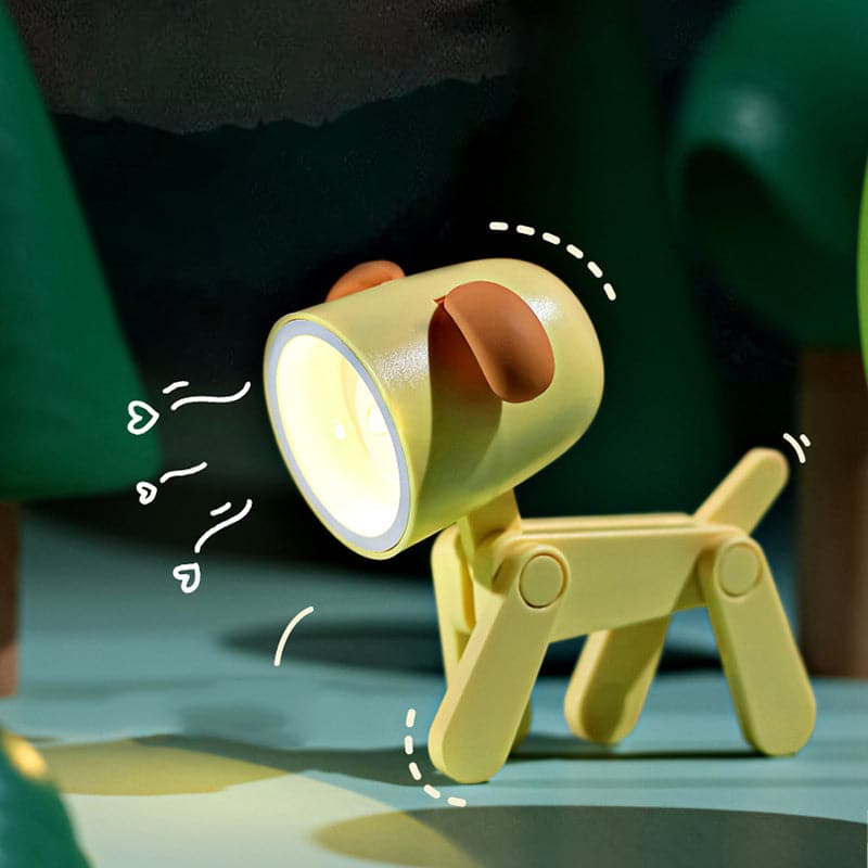 Yellow dog-shaped lamp with a light on a green surface
