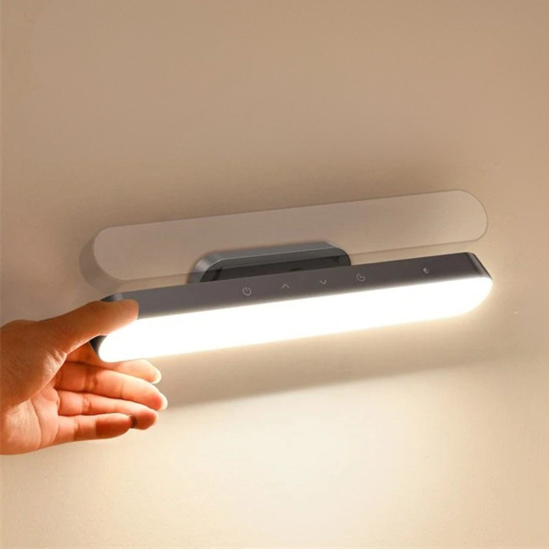 Hand holding a modern wall-mounted light fixture against a neutral background