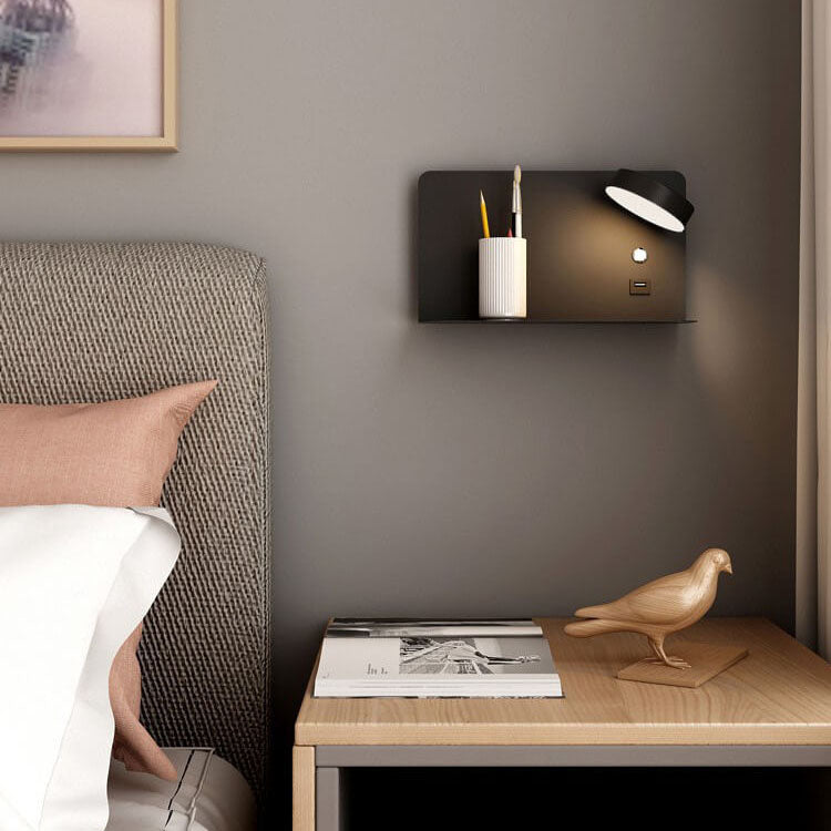 Wall-mounted shelf with a lamp and pen holder above a wooden nightstand with a bird figurine and books.