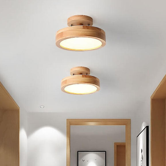 Two wooden ceiling lights in a room with a mirror and framed picture.