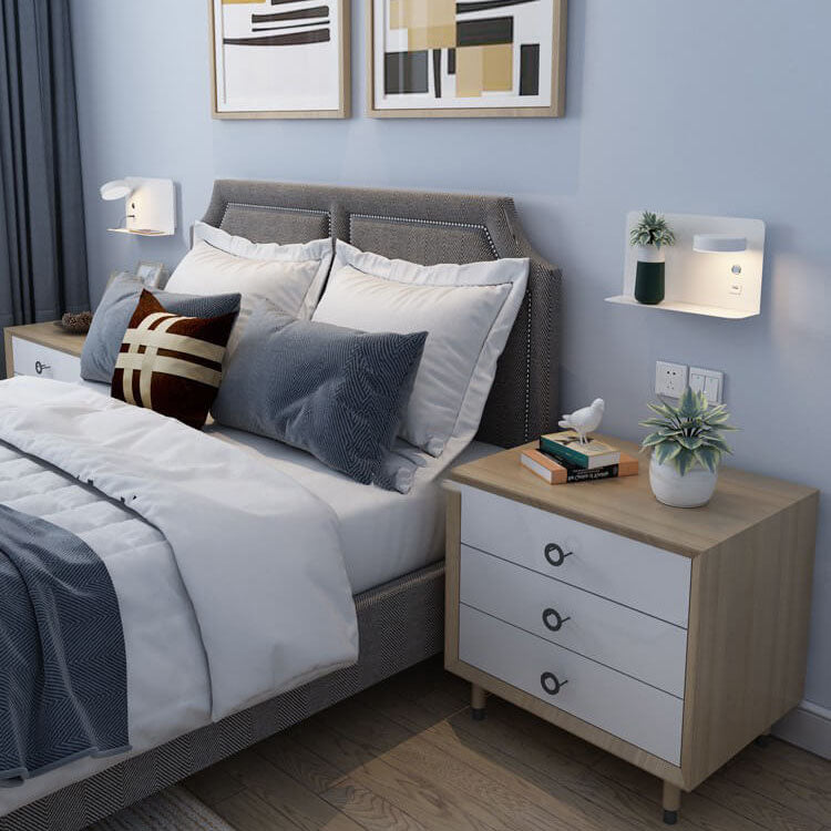 Modern bedroom with a bed, nightstand, and wall art.