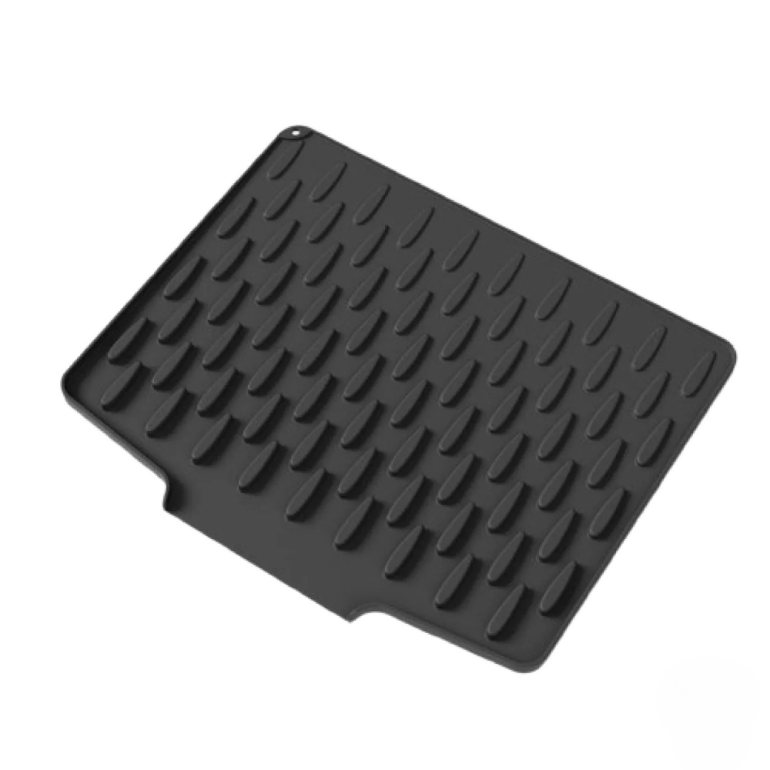 Black rubber mat with textured surface on a white background