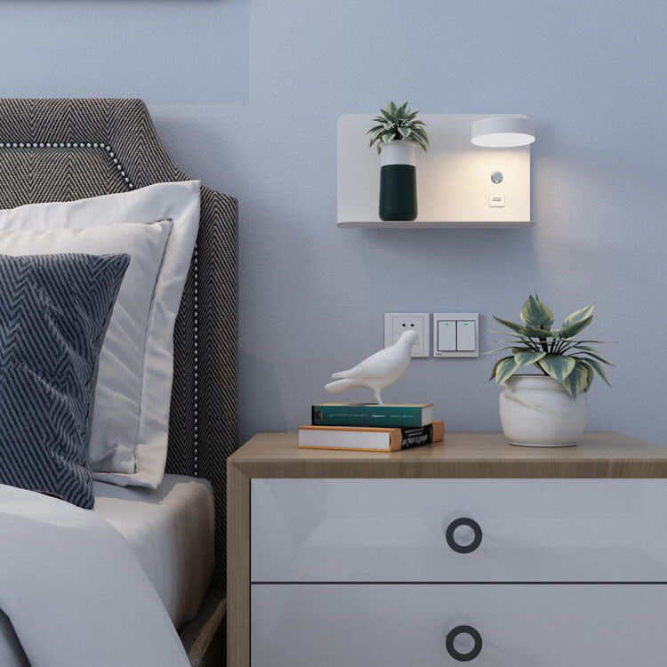Bedroom with a bed, nightstand, and wall-mounted light fixture.