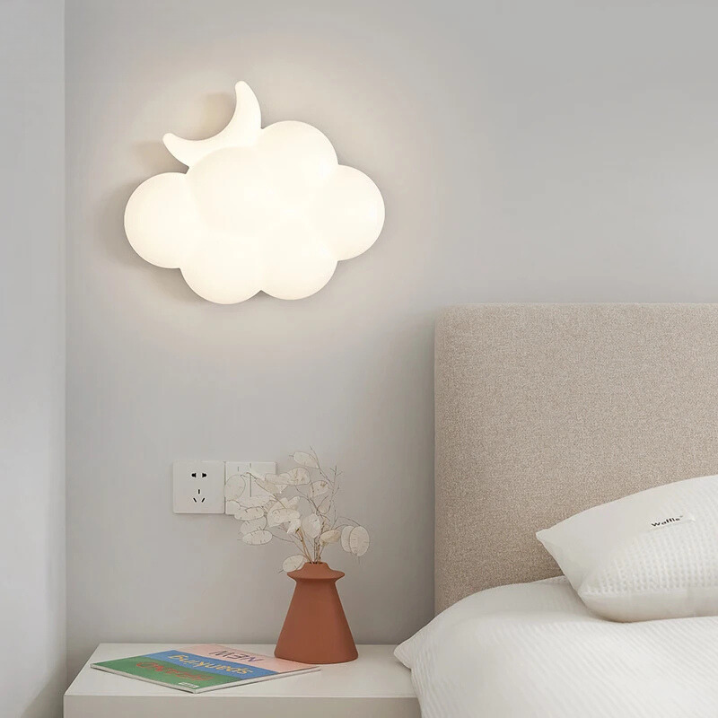 Cloud-shaped wall light above a bed in a bedroom setting