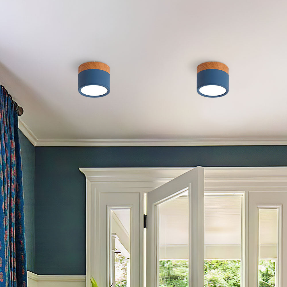 Two blue ceiling lights with wooden accents on a white ceiling.