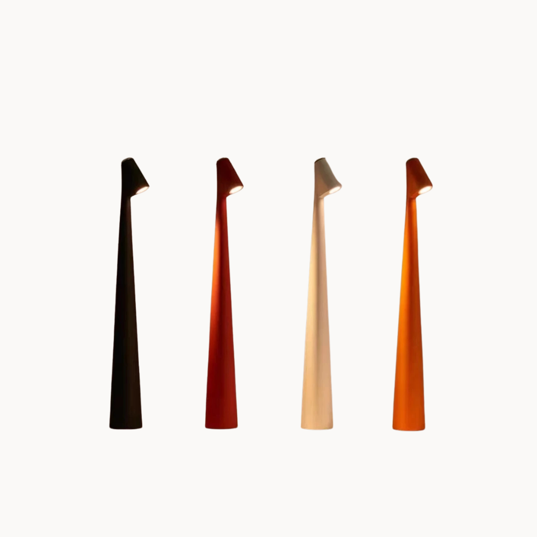 Four wooden hair clips in black, red, beige, and orange on a white background