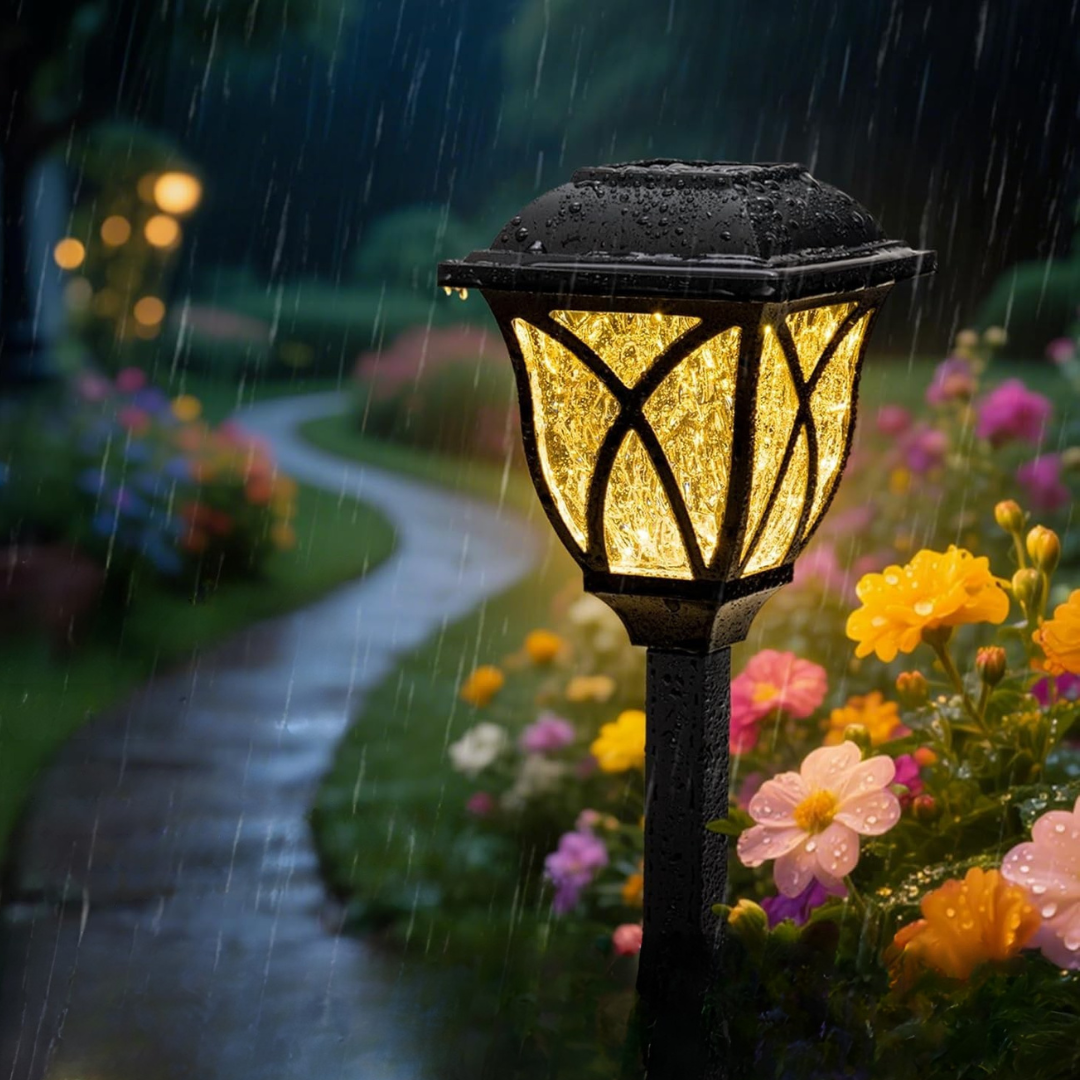 Garden lamp post with glowing light in a rainy garden setting