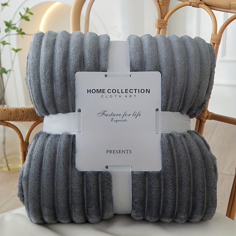 Gray textured blanket with a 'Home Collection' tag on a chair.