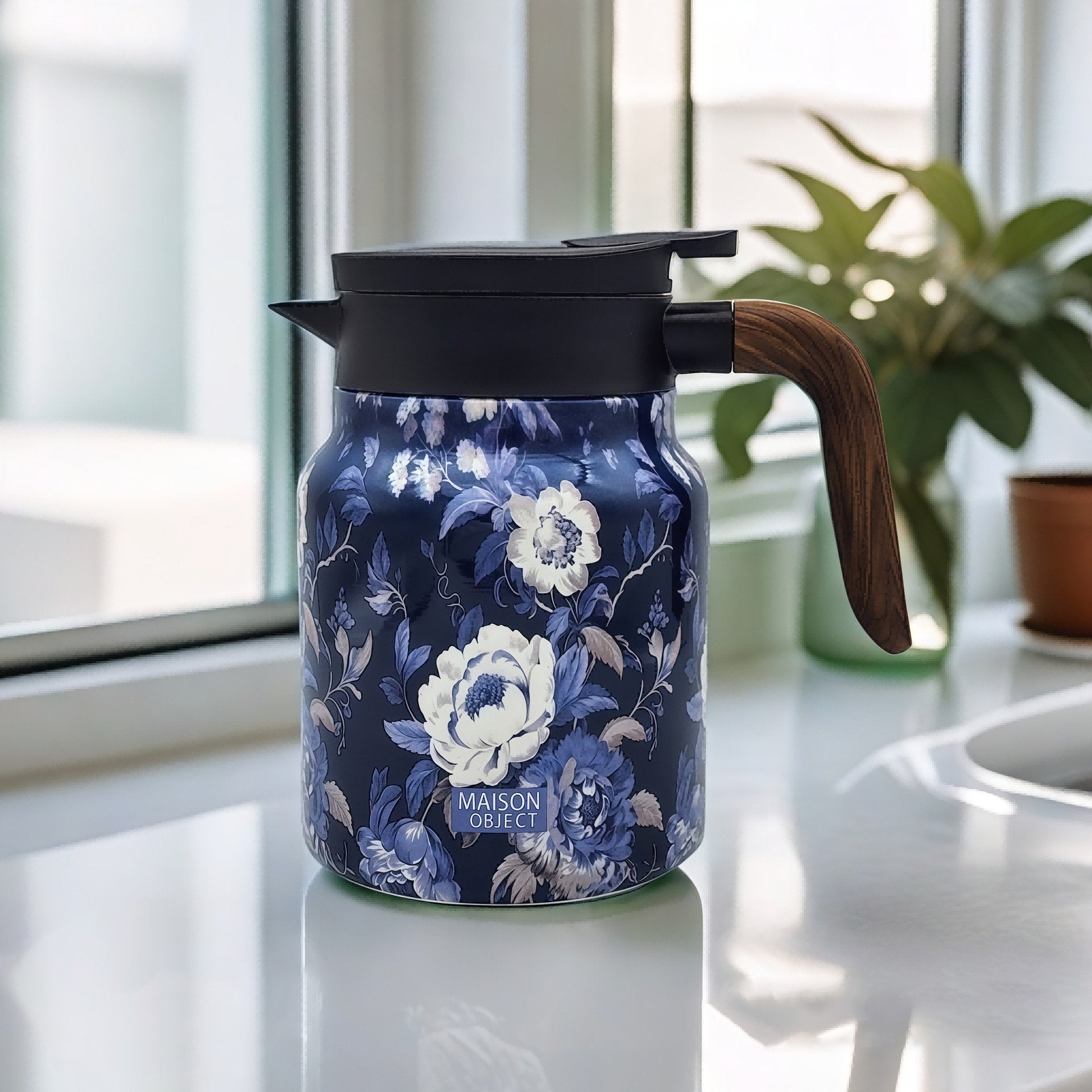 Blue floral-patterned thermos with wooden handle on a light surface