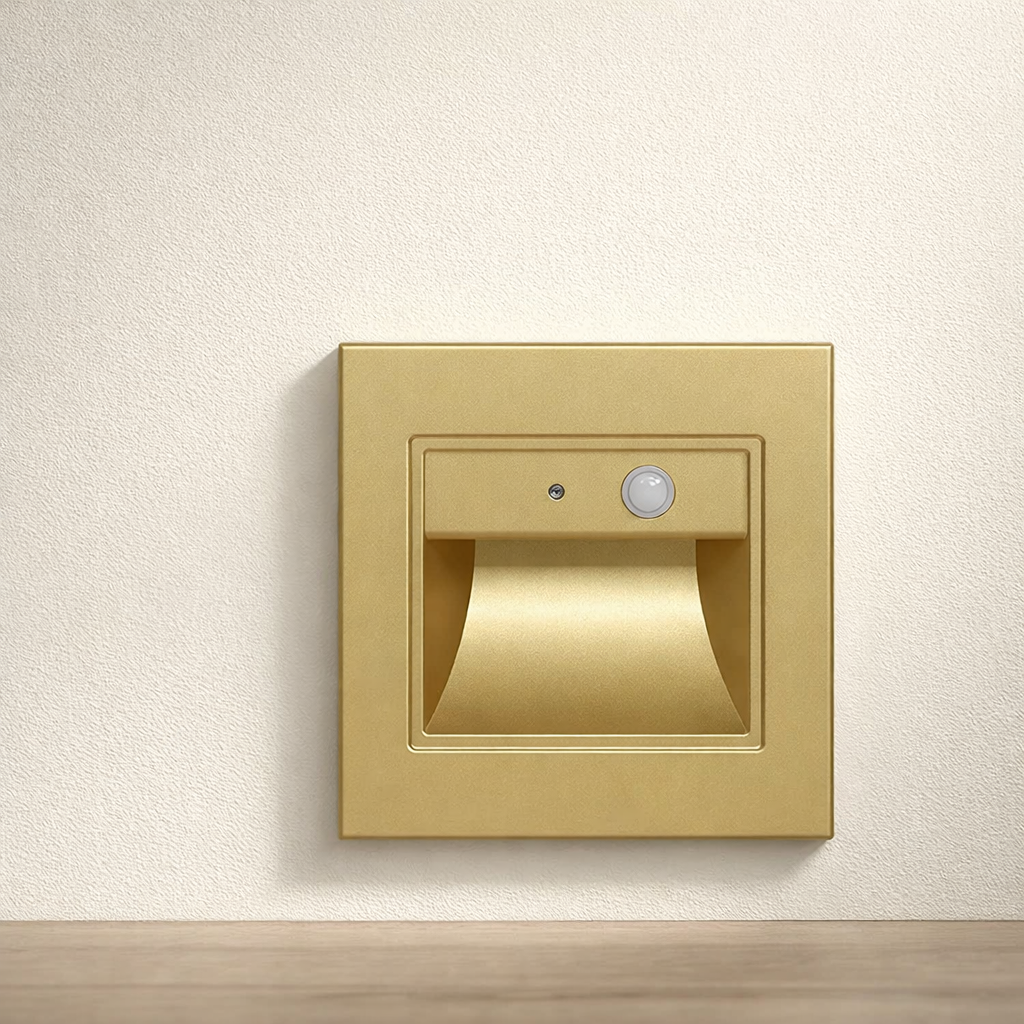 Gold wall-mounted light fixture on a neutral background