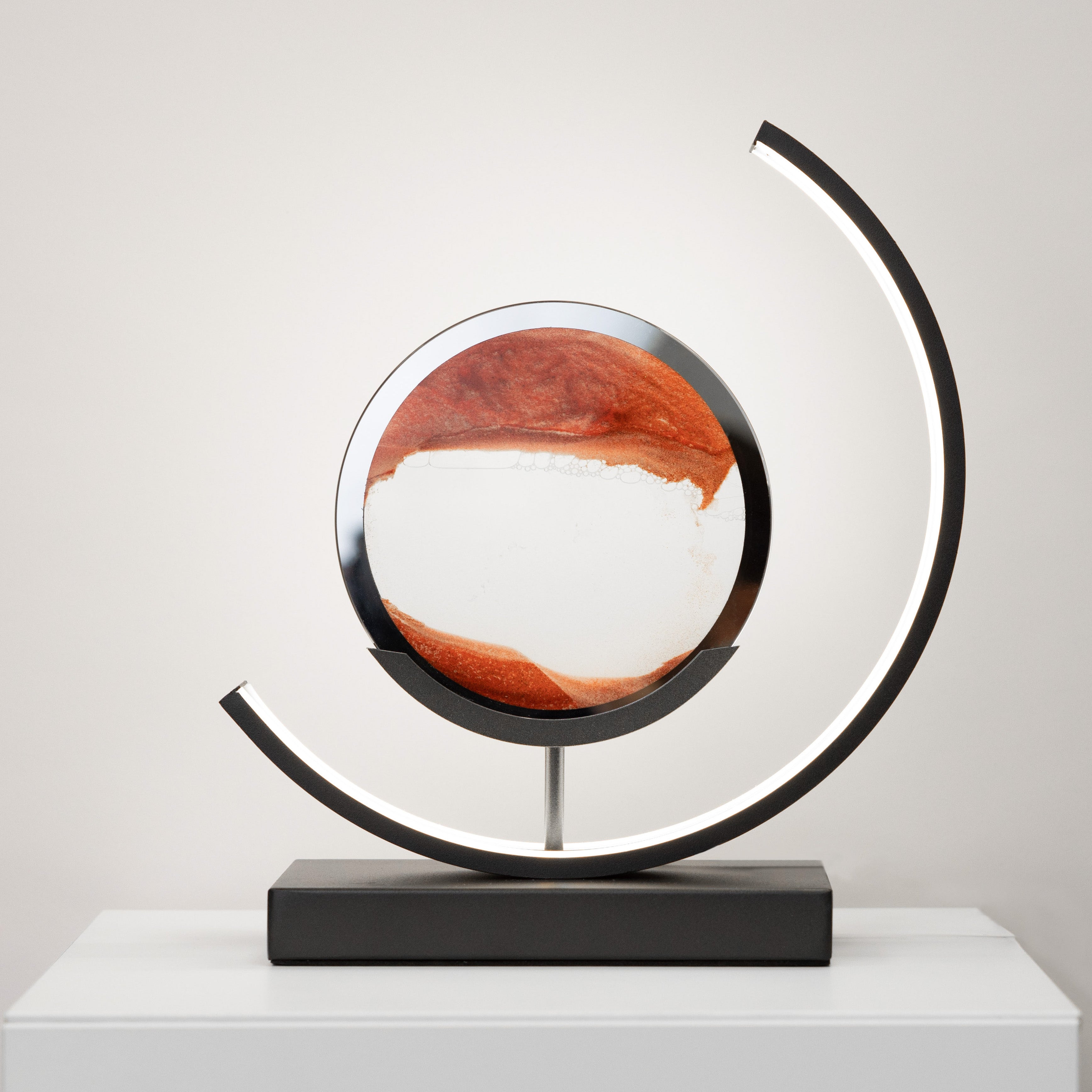 Decorative sphere with a black circular frame on a white surface