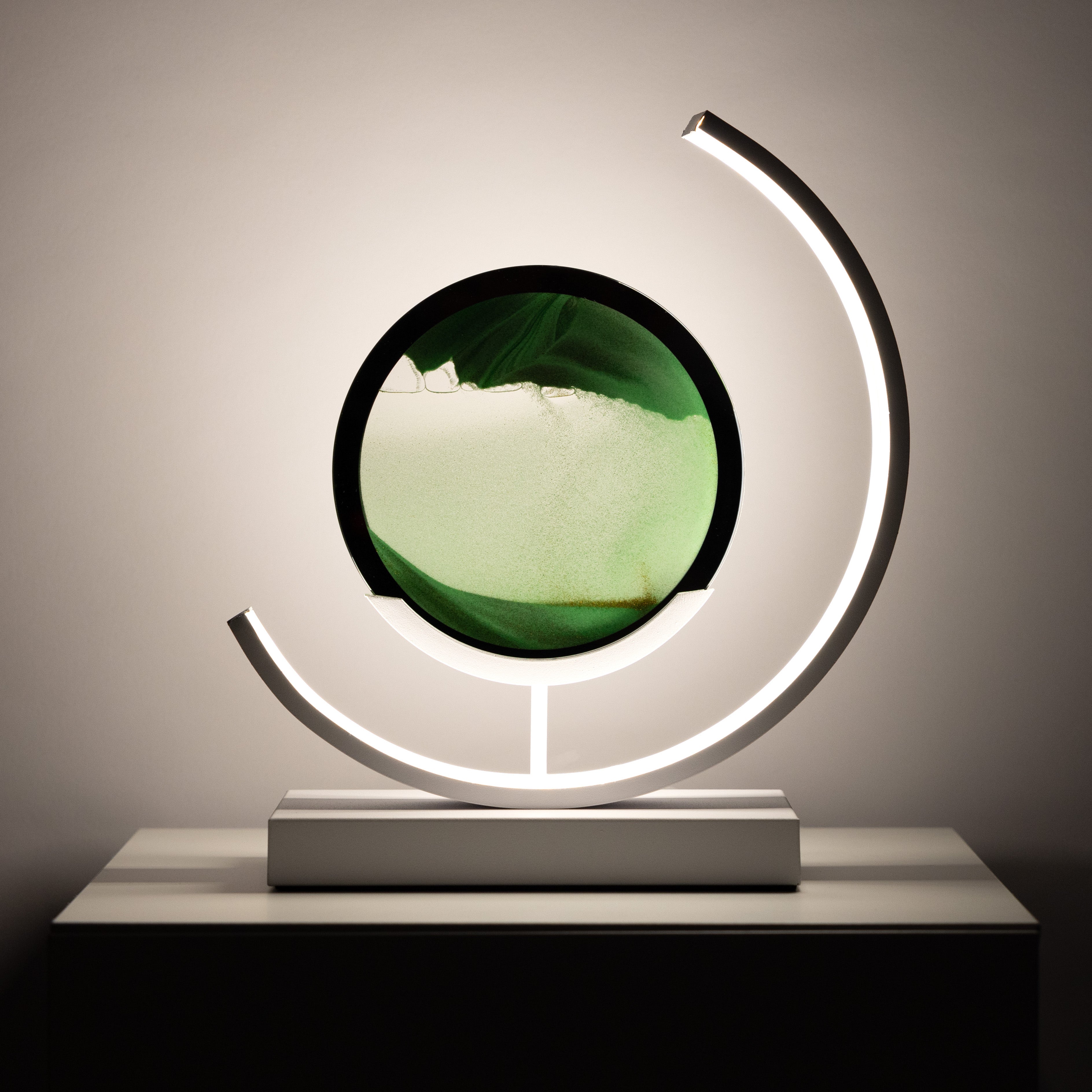 Decorative lamp with a circular design and leaf-like structure on a neutral background
