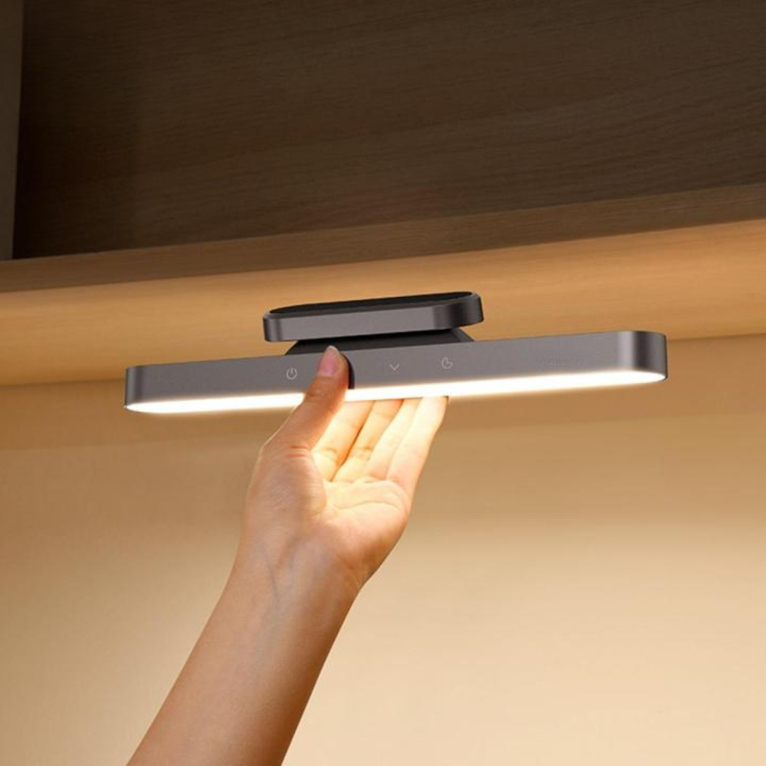 Hand holding a modern LED light fixture against a neutral background