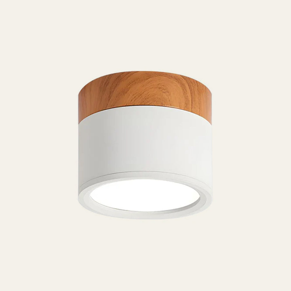 Ceiling light fixture with wooden top and white base on a beige background
