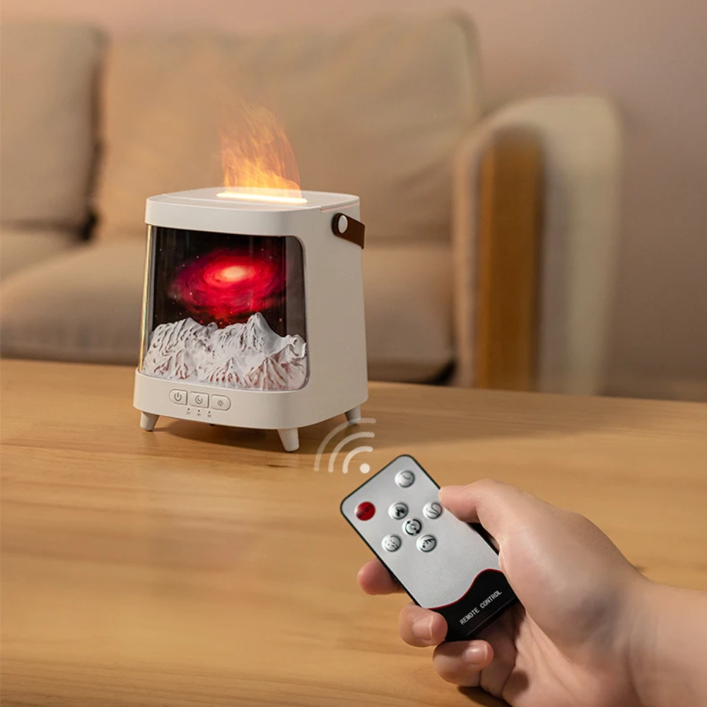 Tabletop fireplace with flame effect on a wooden surface, held by a hand with a remote control.