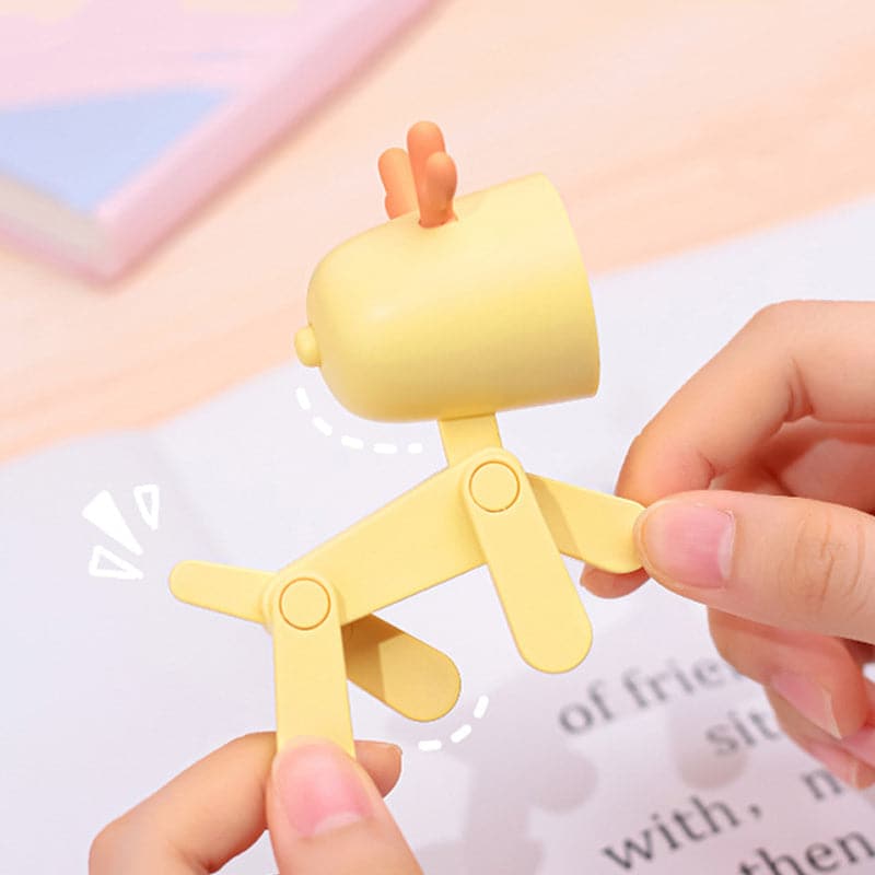 Yellow chicken-shaped clip held by a hand with a soft focus background