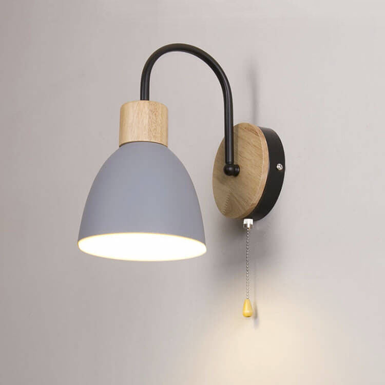 Wall-mounted lamp with gray shade, wooden base, and black arm on a light gray background