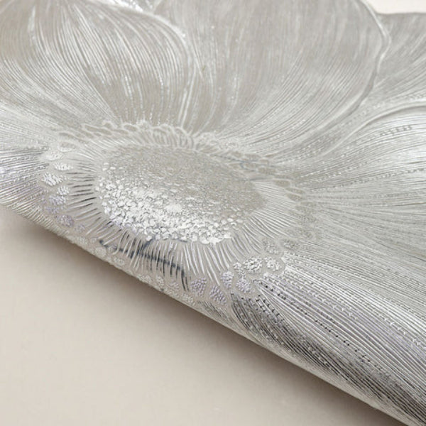 Close-up of textured silver fabric with a neutral background