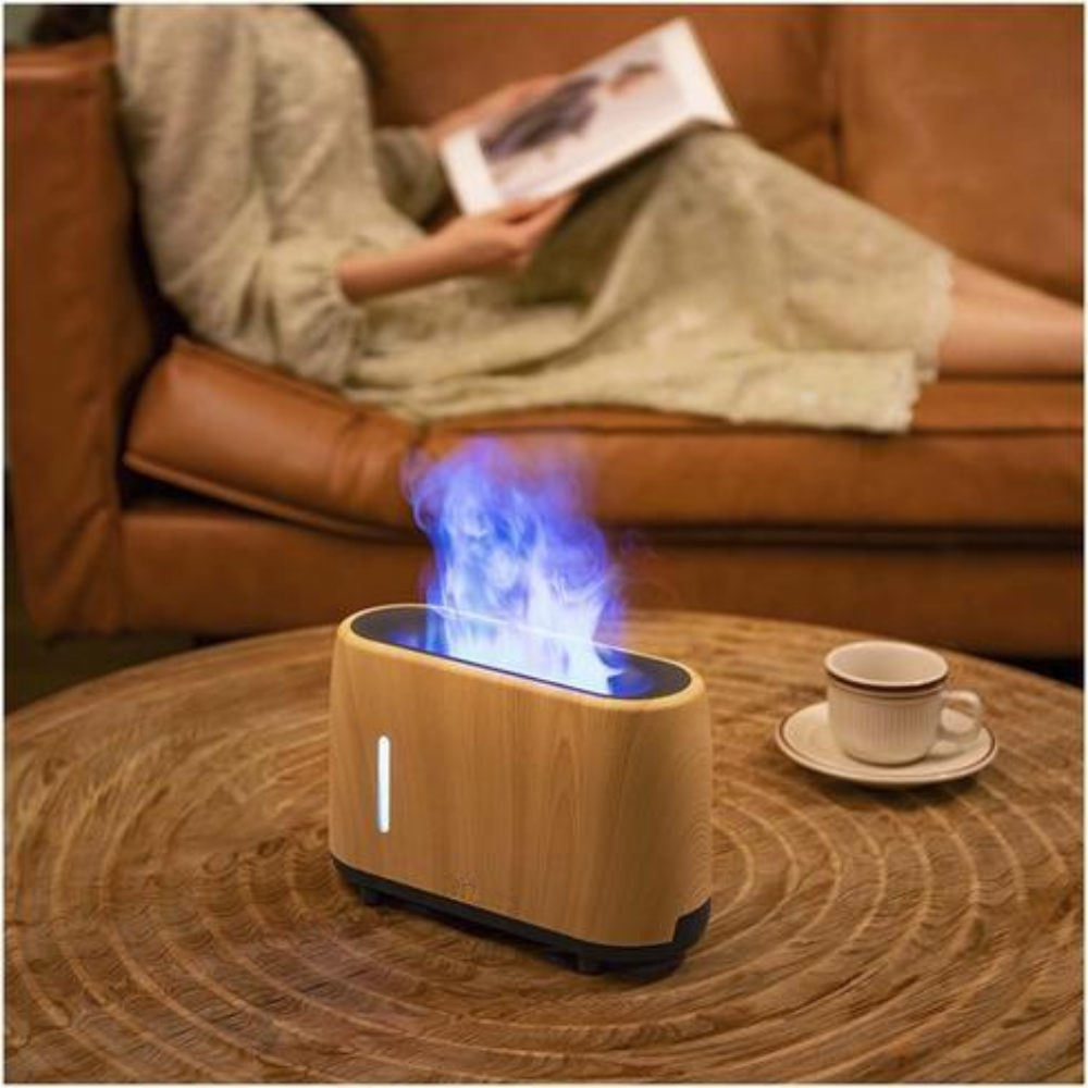 Wooden humidifier with blue light on a wooden table, person reading magazine on brown sofa.