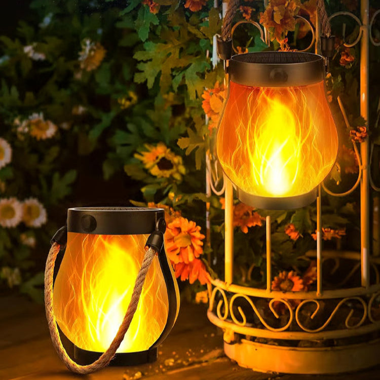 Two illuminated lanterns with a decorative metal stand against a dark background.