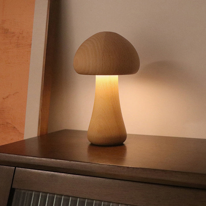 Wooden mushroom-shaped lamp on a wooden surface with a warm glow.