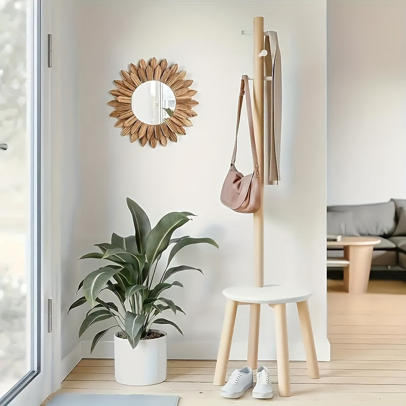 Wooden coat rack with a bag, plant, and shoes in a room setting.