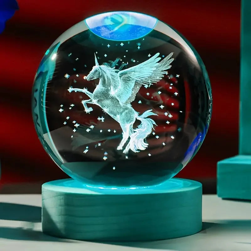 Crystal ball with a unicorn design on a stand against a colorful background