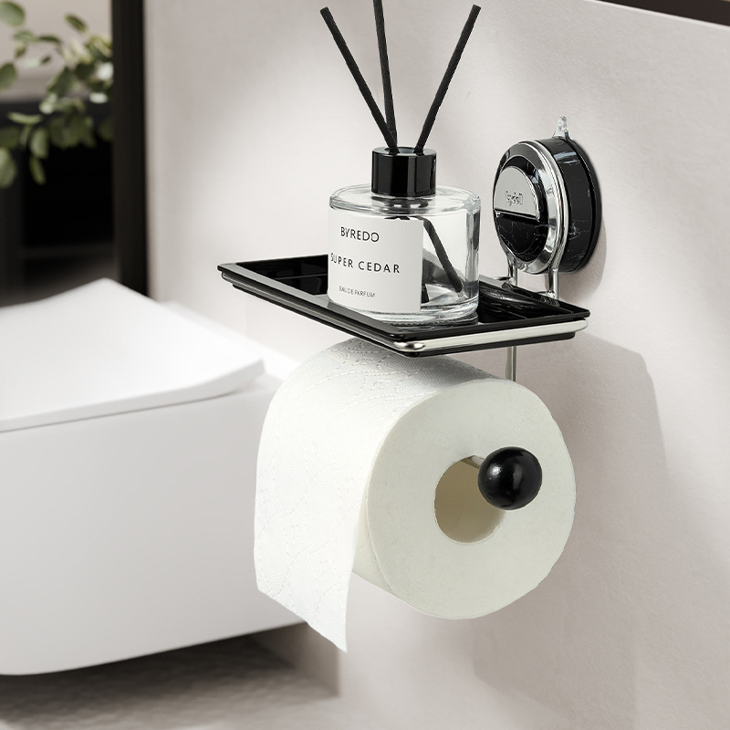 Bath mat with a roll of toilet paper and a diffuser on a shelf.
