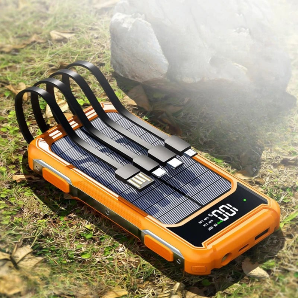 Orange solar power bank on grass with a blurred background