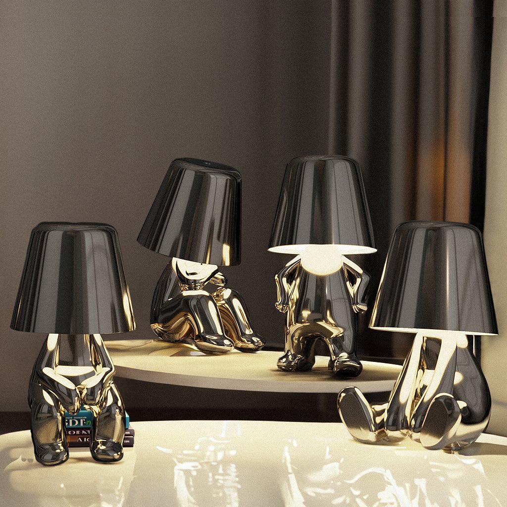 Set of unique table lamps with black and gold design on a reflective surface.