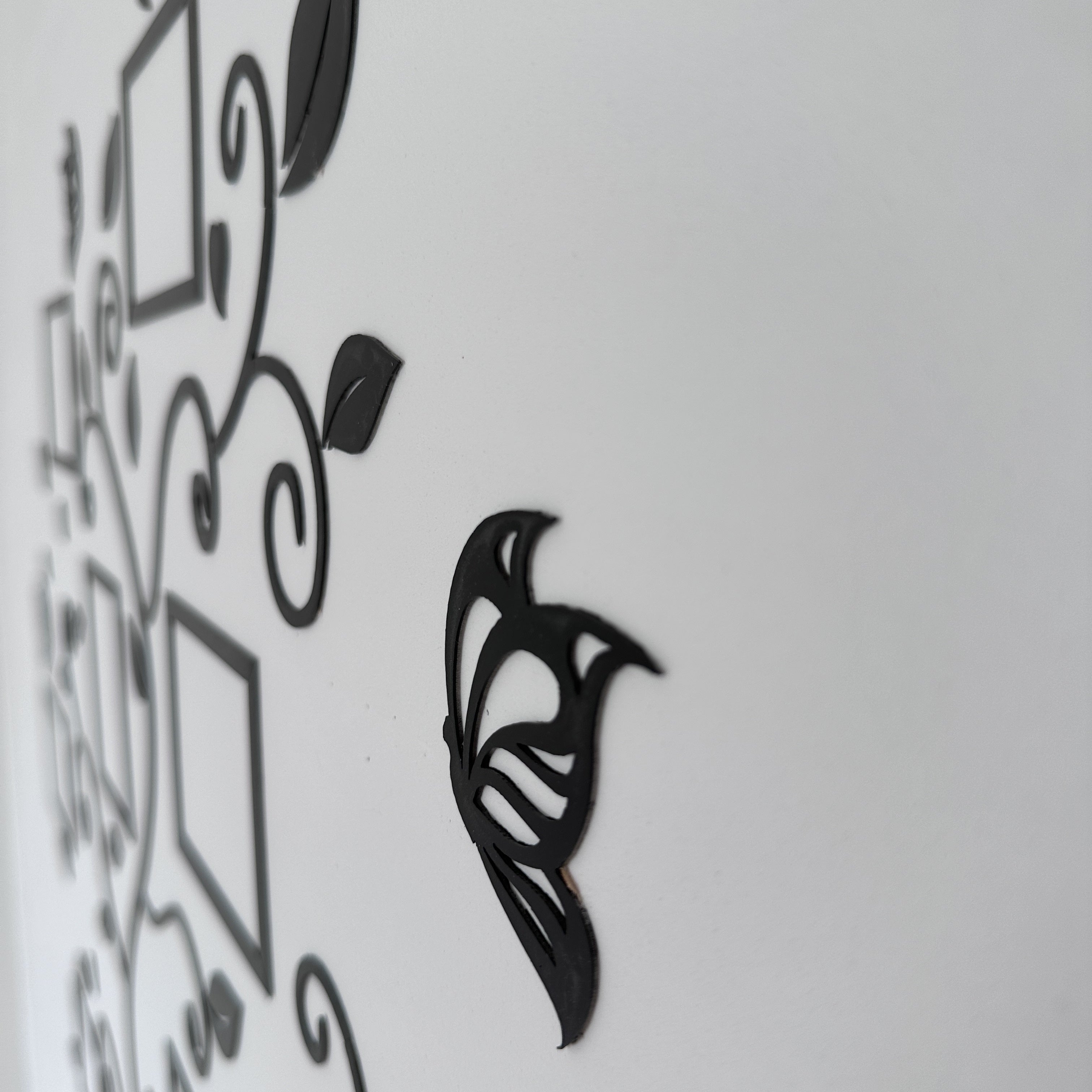 Black decorative wall art on a white background