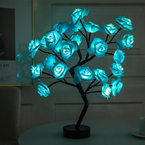 Decorative LED tree with blue glowing flowers on a dark background