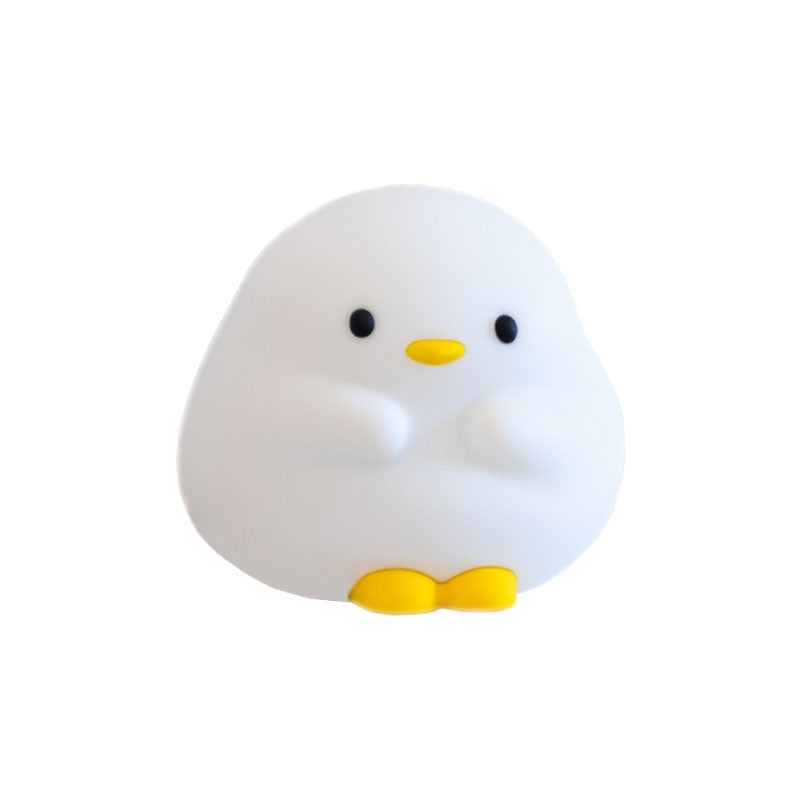 White duck-shaped object with black eyes and a yellow beak on a white background