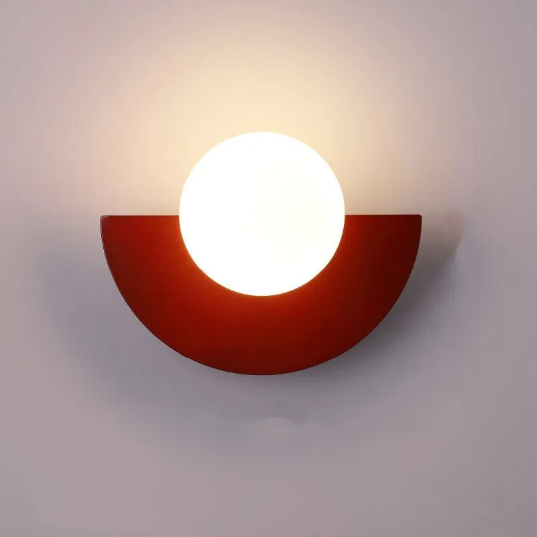 Wall-mounted light fixture with a red semi-circular base on a gray background