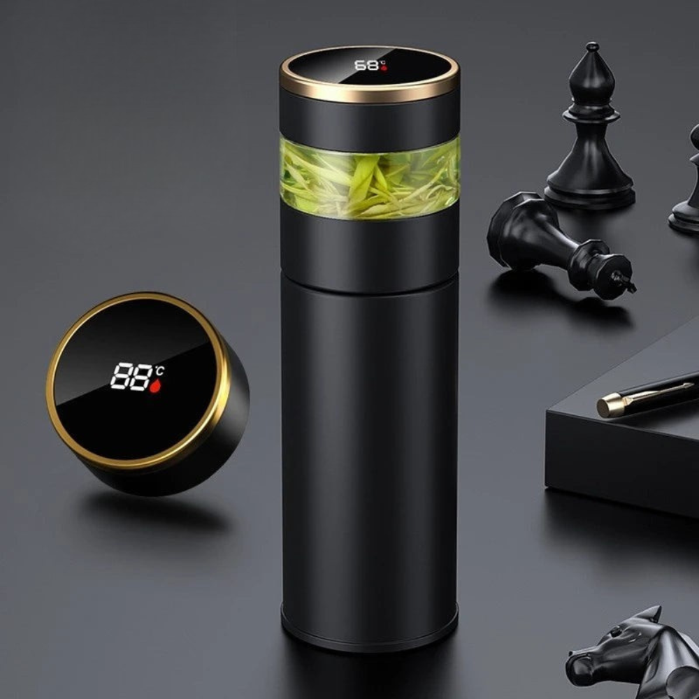 Black thermos with digital temperature display on a dark surface with decorative items.
