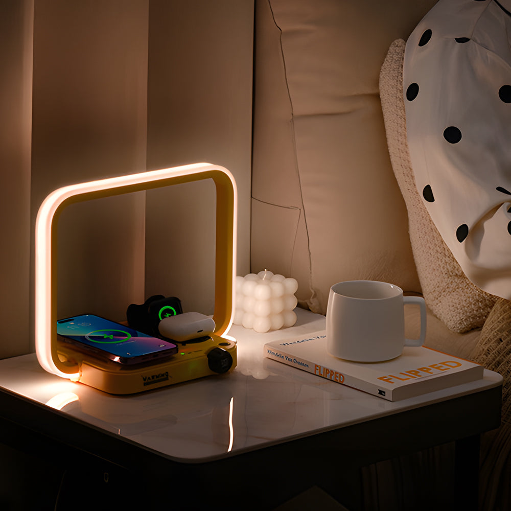 Nighstand with lit lamp, phone, mug, and books in a cozy bedroom setting