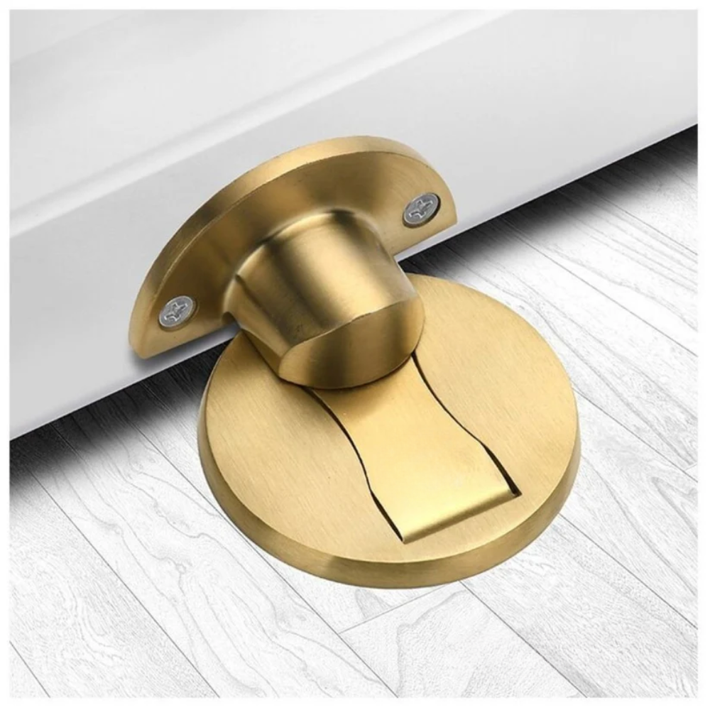 Gold door stopper on a white floor