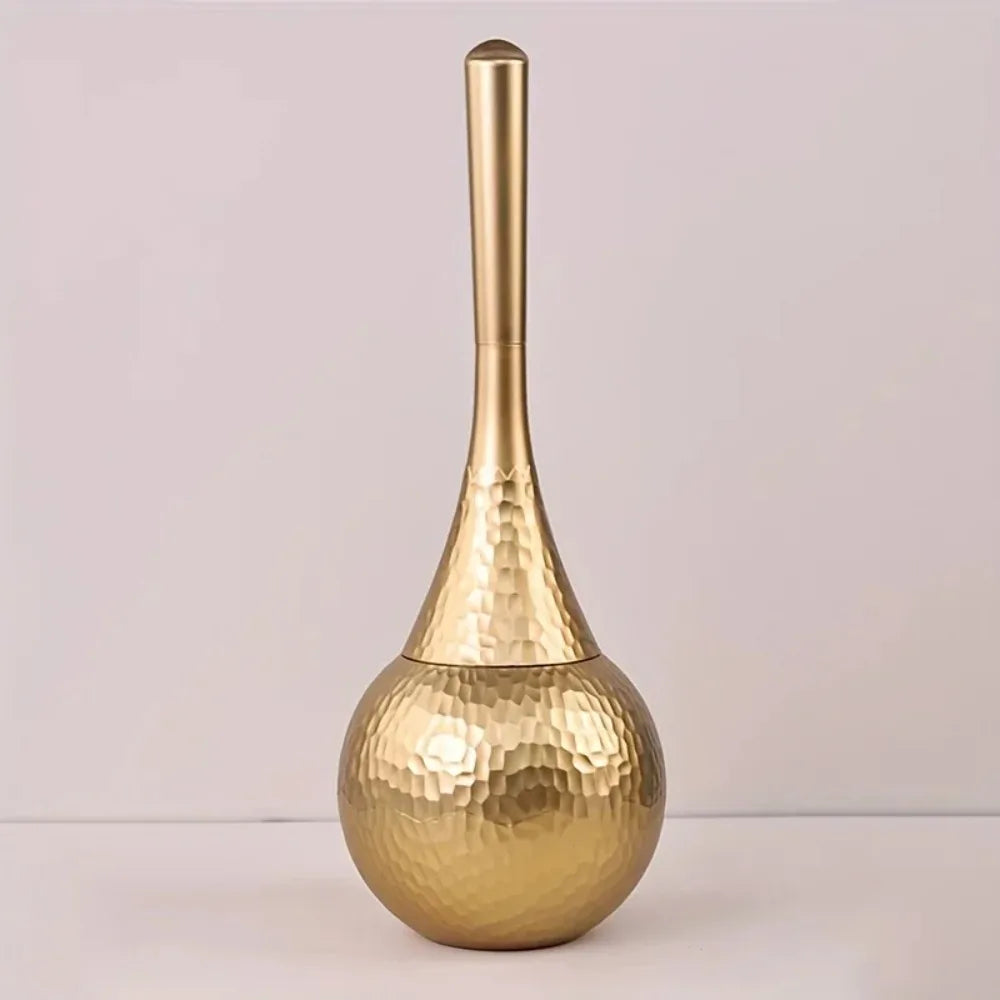 Gold vase with a textured design on a light gray background