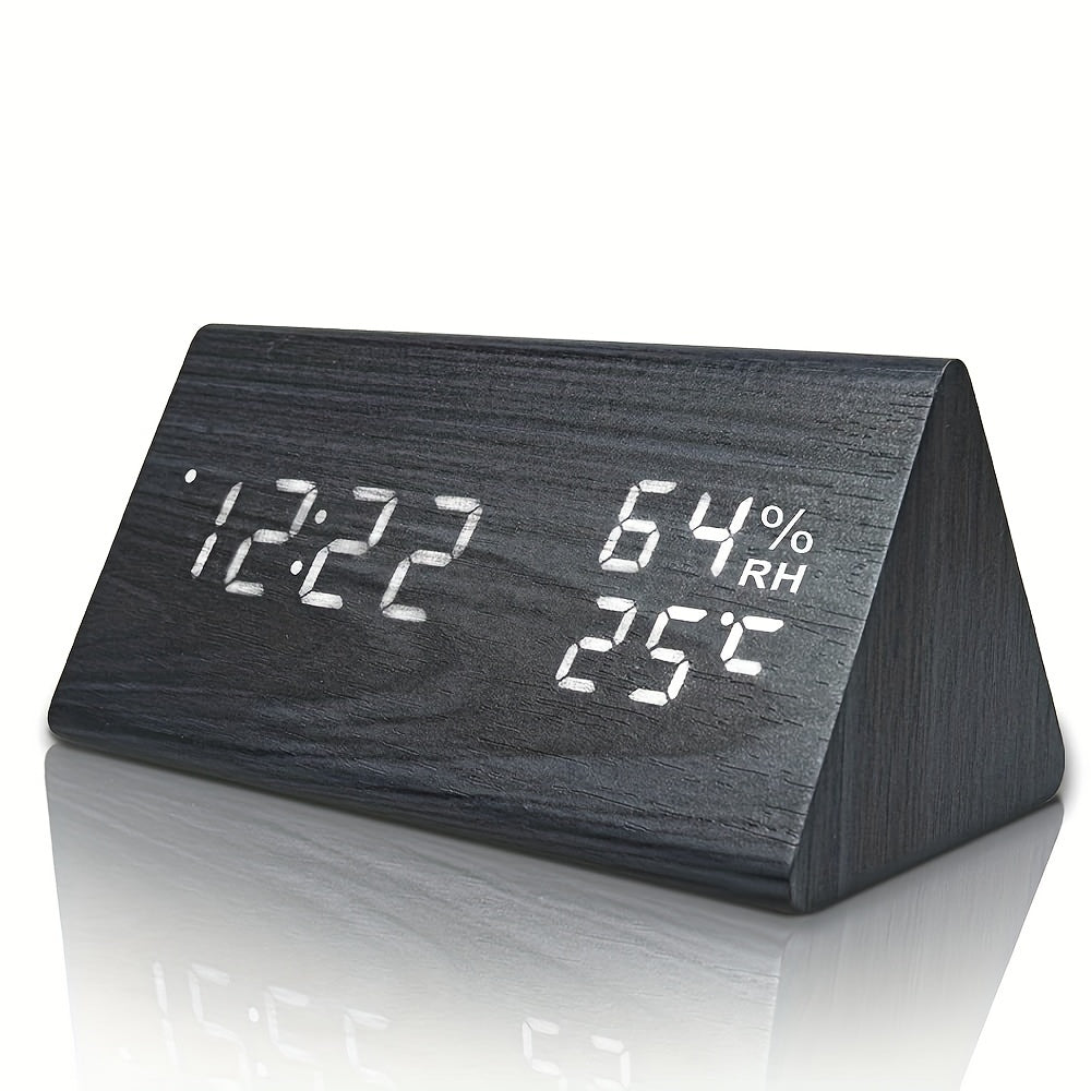 Triangular wooden clock with digital display on a white background