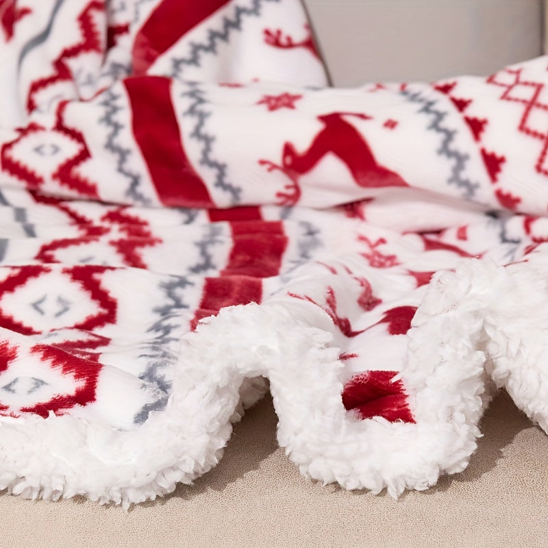 Folded blanket with red and gray pattern on a beige surface
