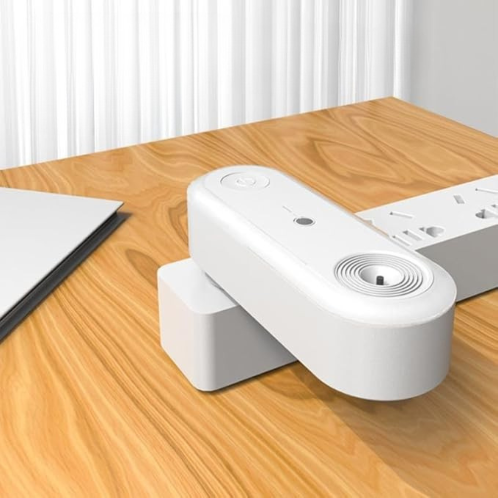 White electronic device on a wooden table with a blurred background