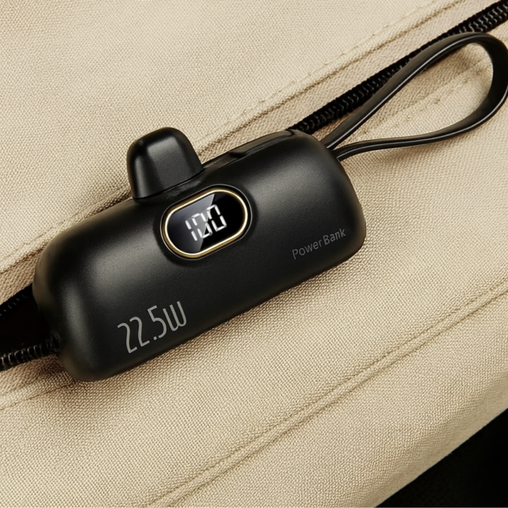 Black power bank with digital display on a beige fabric background