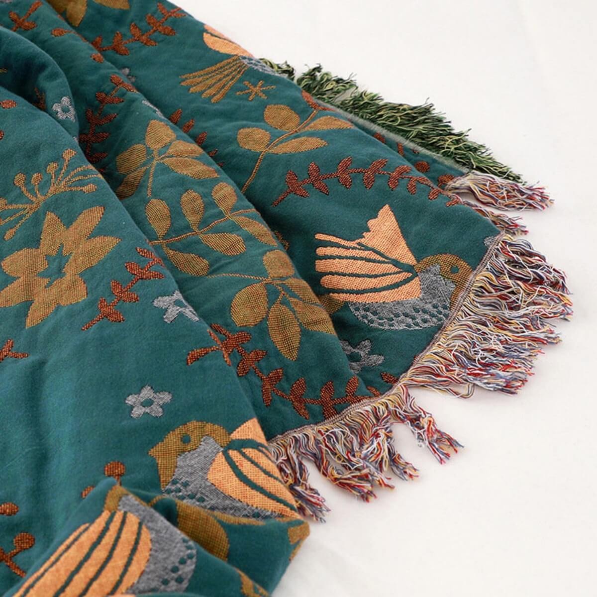 Decorative blanket with nature-themed patterns on a white background