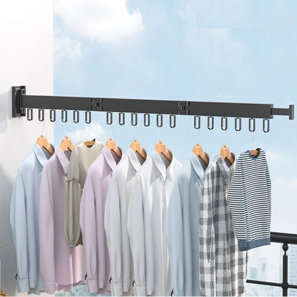 Clothing rack with various shirts hanging on it against a blue sky background