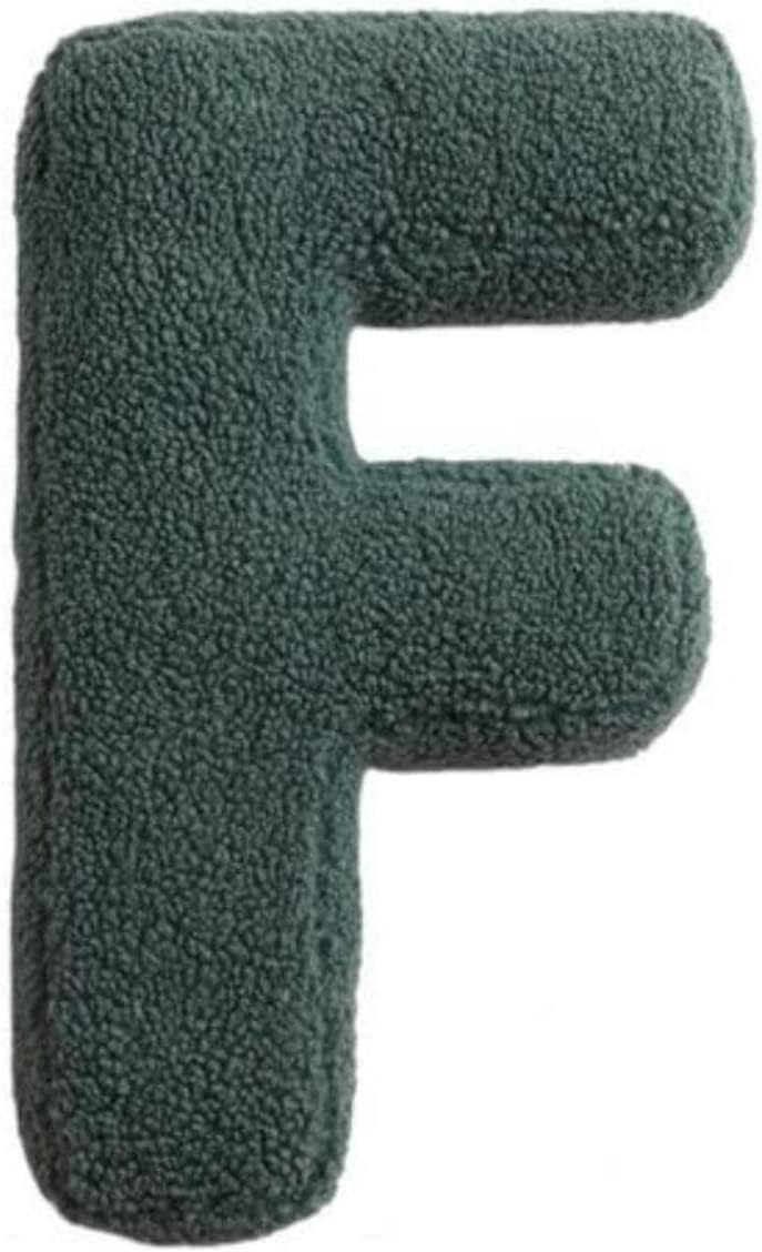 Green letter 'F' plush toy on a white background