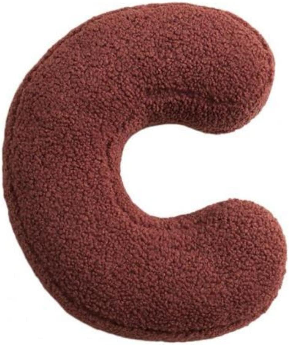 Brown U-shaped pillow on a white background