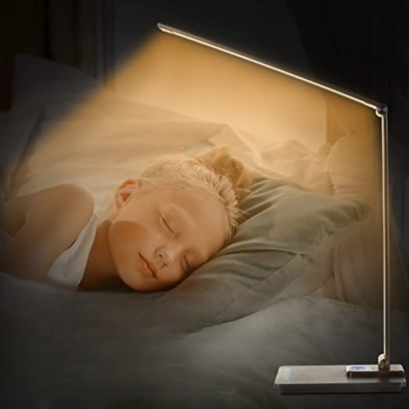 Child sleeping with a glowing lamp next to them