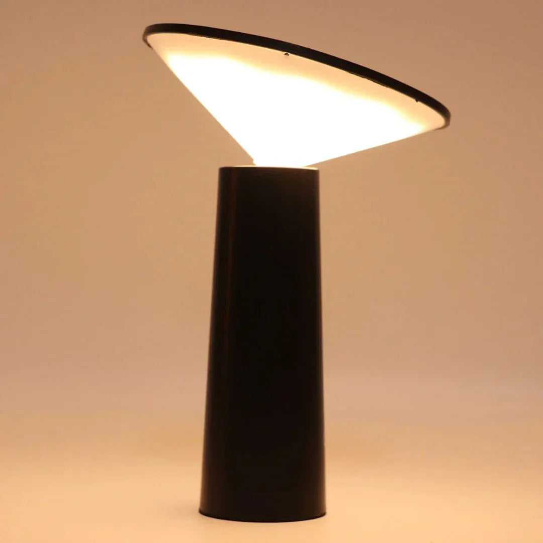 Black cylindrical lamp with a white light on a beige background
