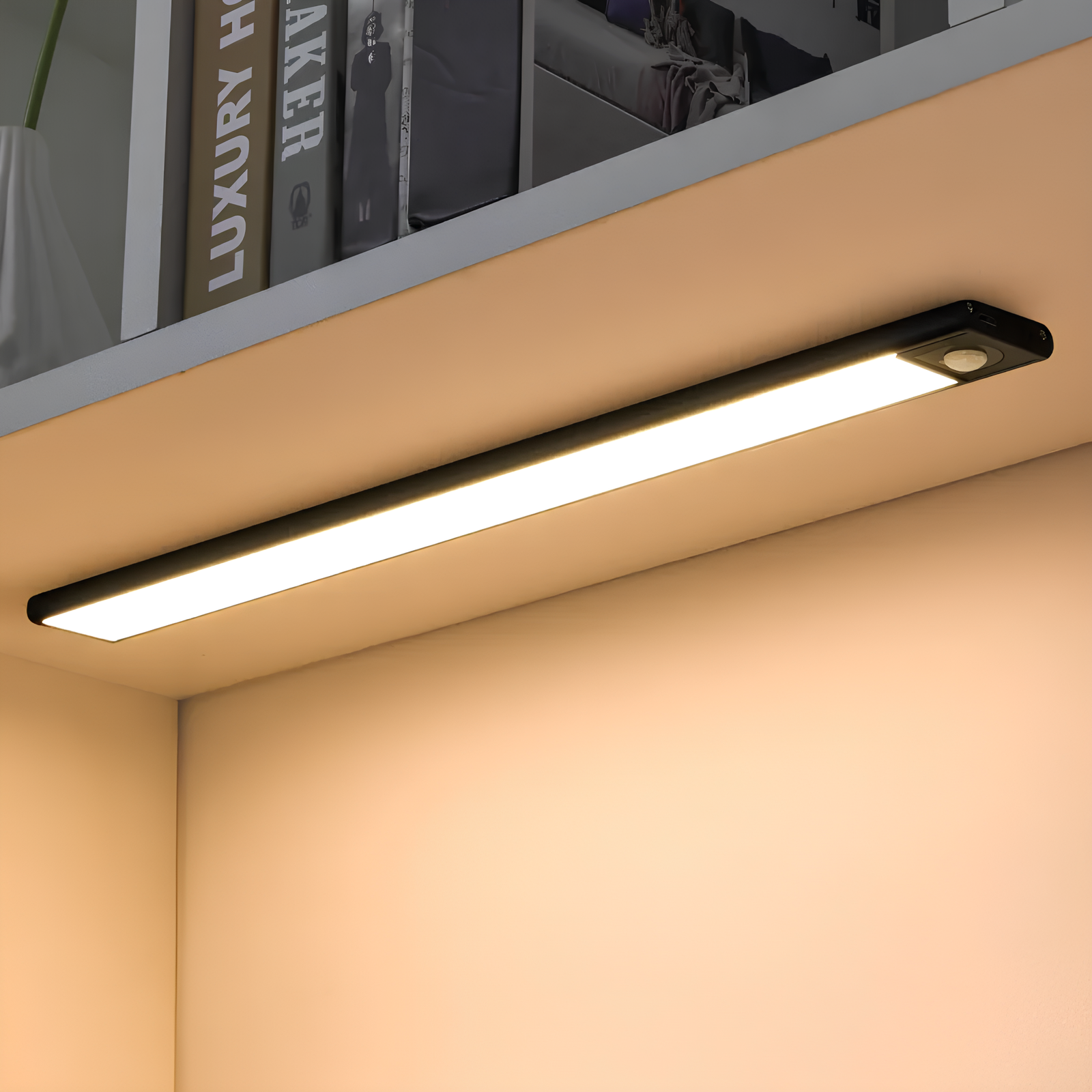 Under-cabinet LED light strip on a kitchen shelf with books in the background