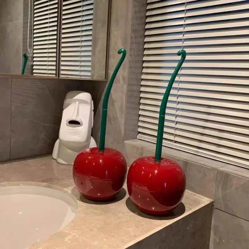 Two red cherries with green stems on a bathroom counter.